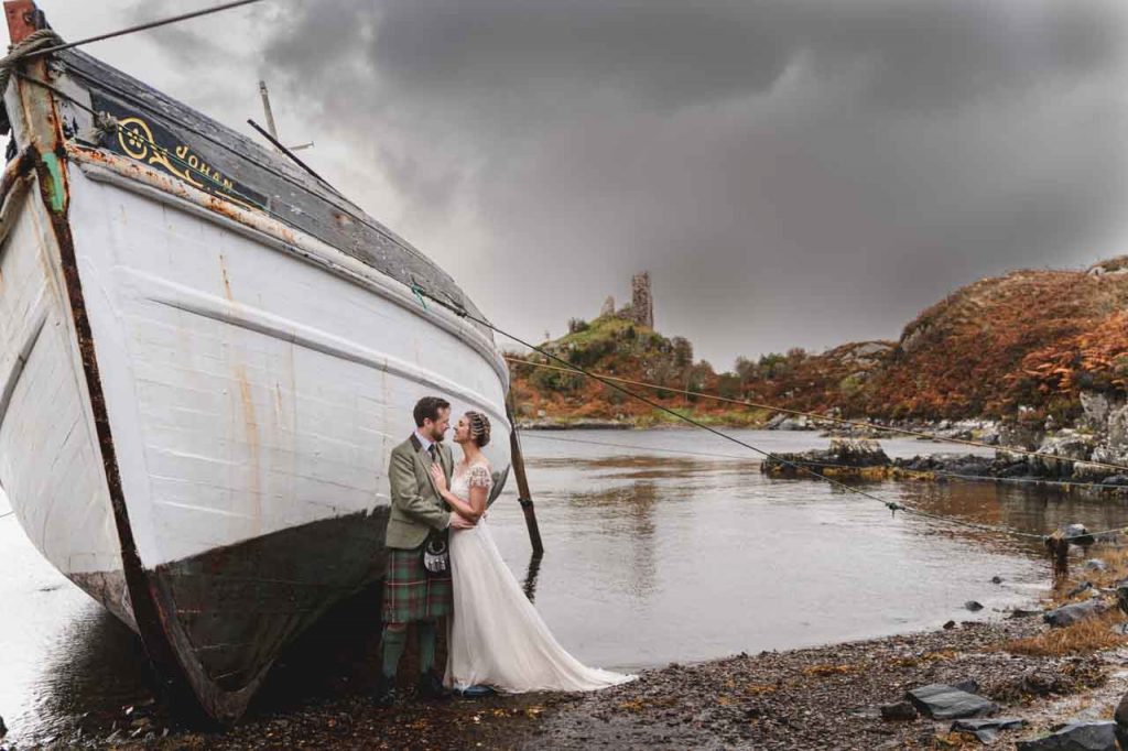 Isle of Skye elopement wedding fearuring a ruined castle and an old fishing boat