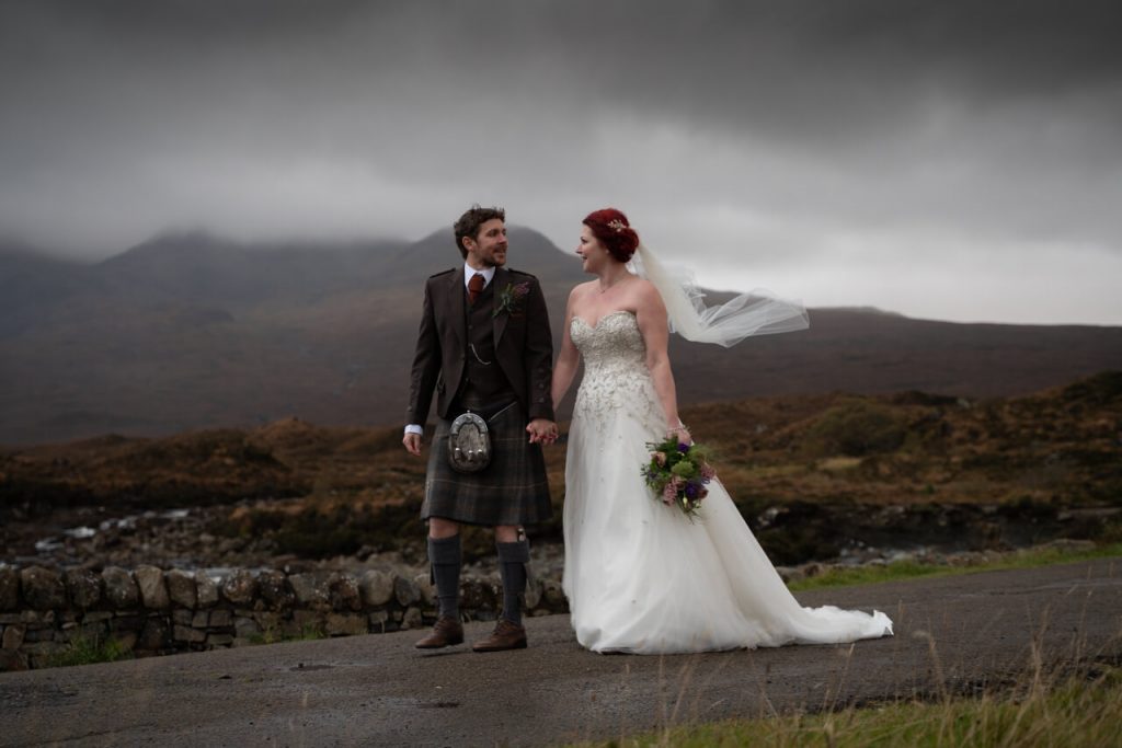Couple getting married ona. dark afternoon on a bridge on Skye