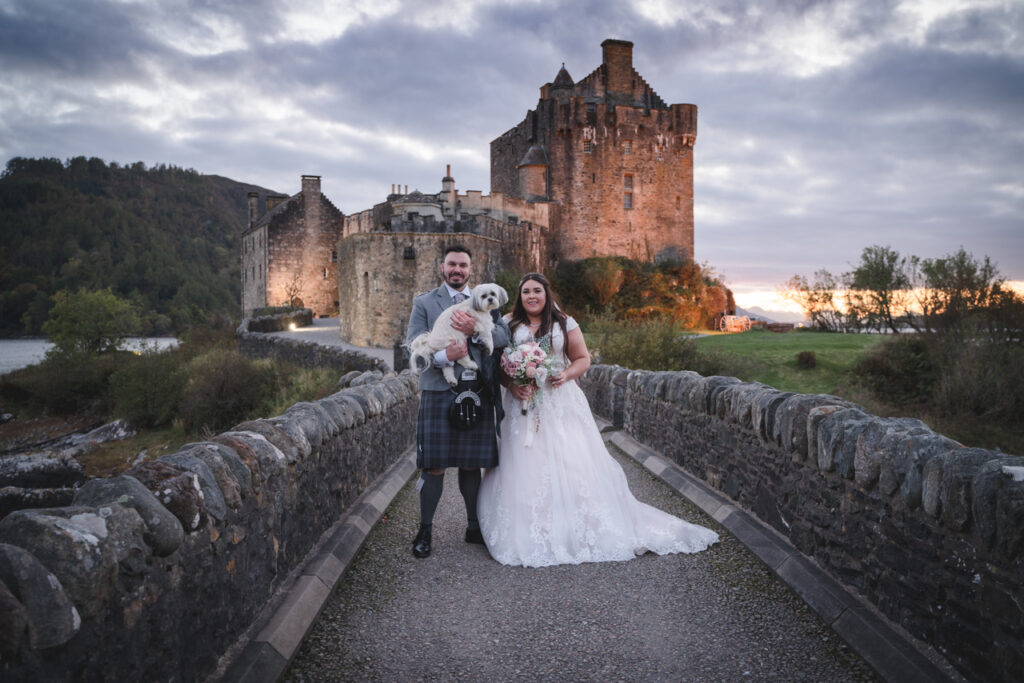 Bride and groom at Eilean Donan getting married in a famous scottish castle near Skye.