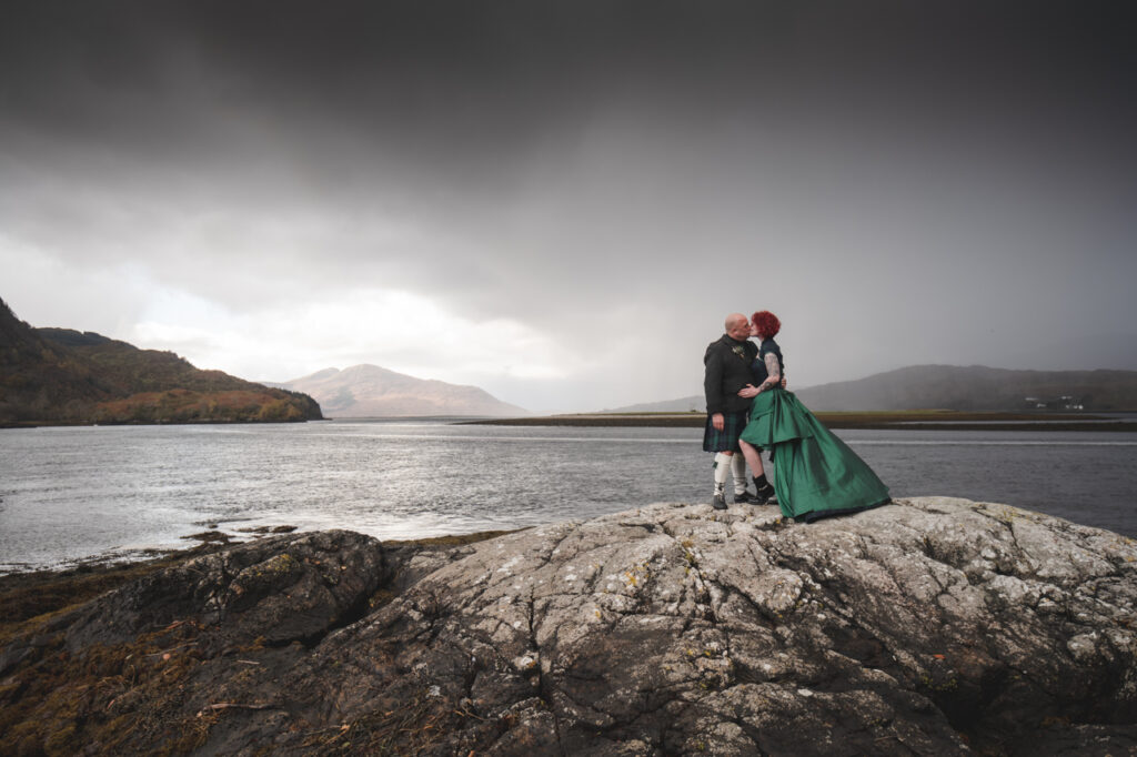 bride wearing a green wedding dress against moody skies