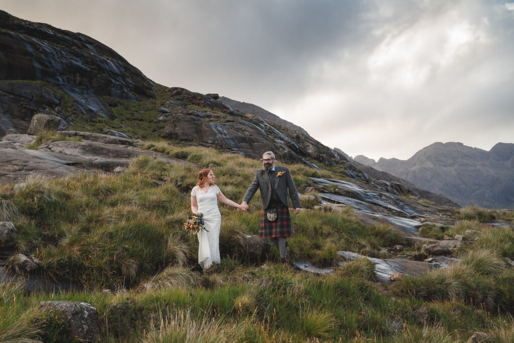 Isle of skye elopement photographer captures bride and groom with local flowers at elopement wedding