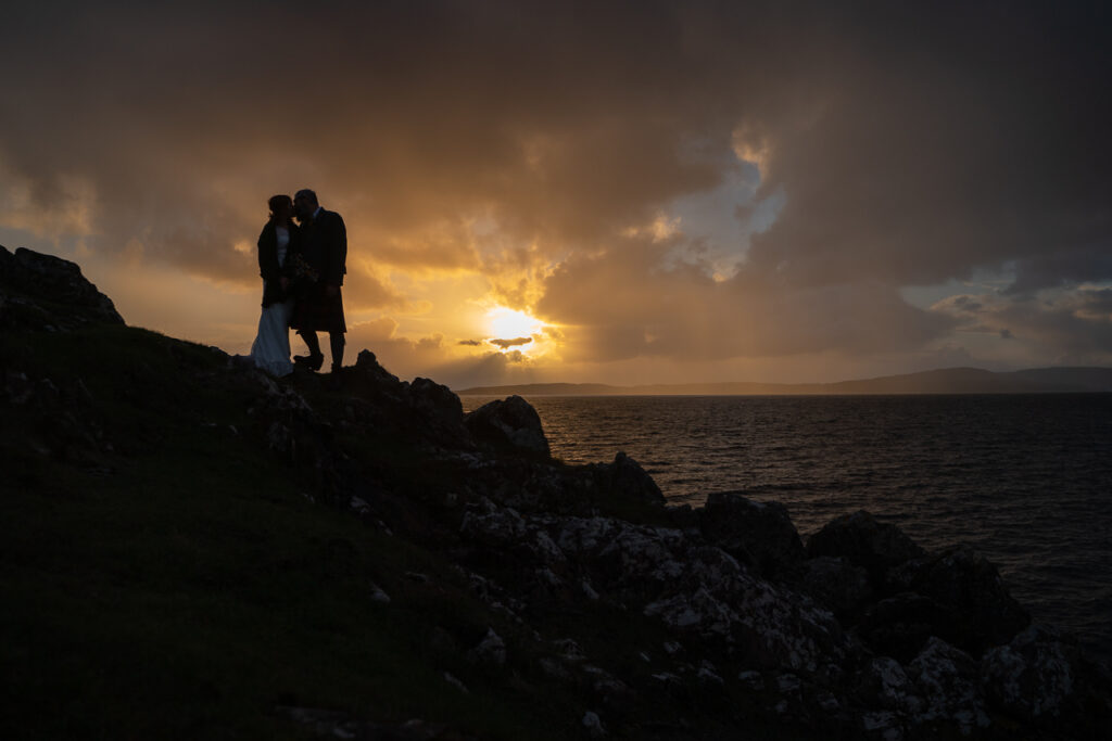 eloping tpo Skye and kissing at sunset