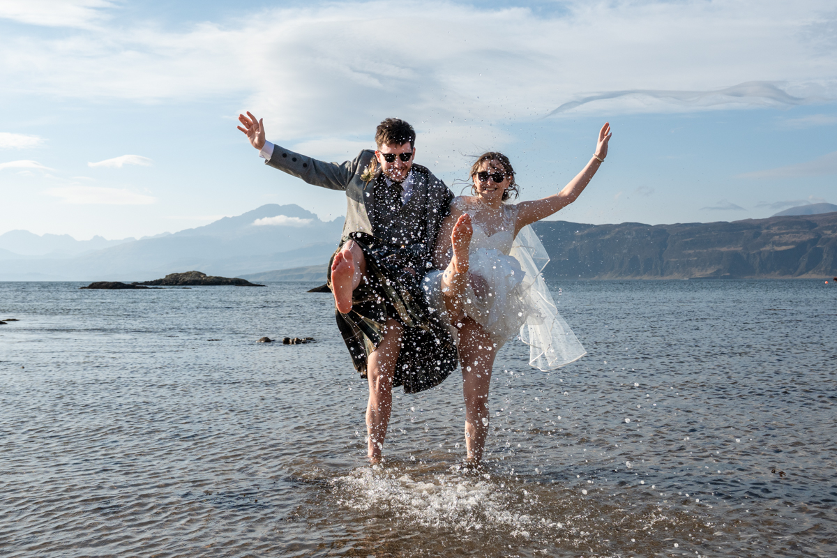 Outdoor wedding ceremony in Scotland on the Isle of Skye ends with a splash in the sea!