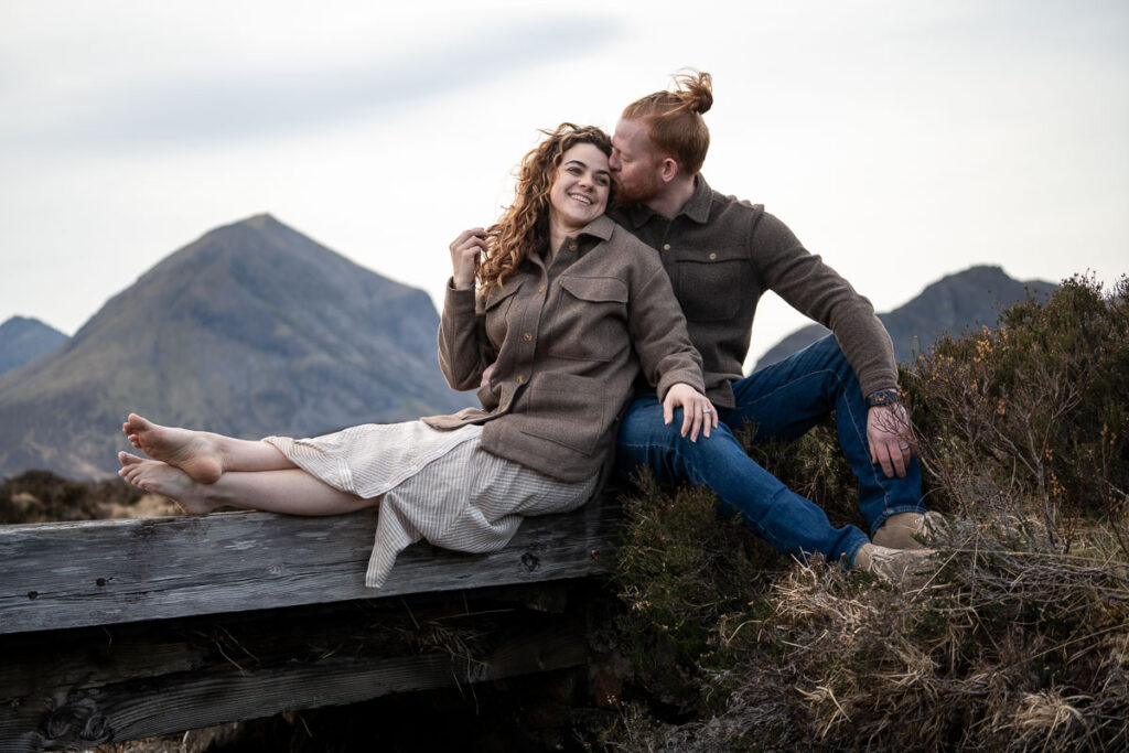 Man and woman sitting on a bridge on the Isle of Skye, by an Isle of Skye Vacation Photographer