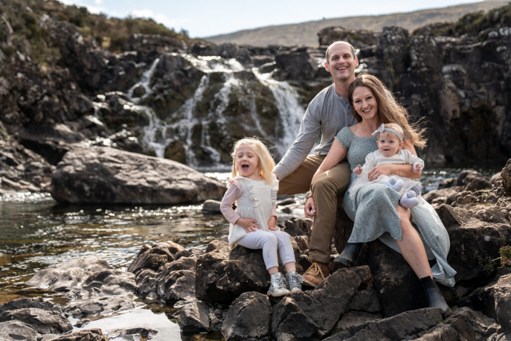 What Can Go Wrong on the Isle Of Skye family with parents and two children sitting on a rock on a family vacation on the Isle of Skye