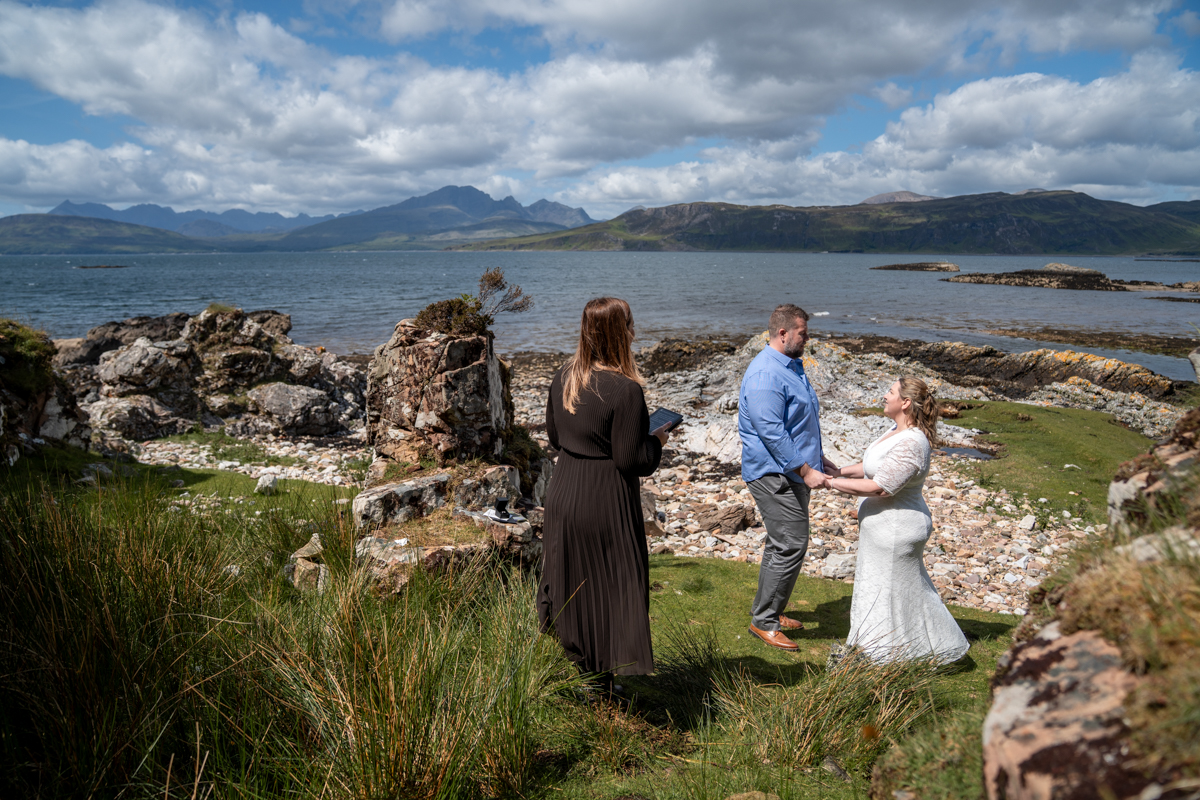 Sunset elopement overlooking the sea loch at Elgol village, Isle of Skye, with soft golden light.