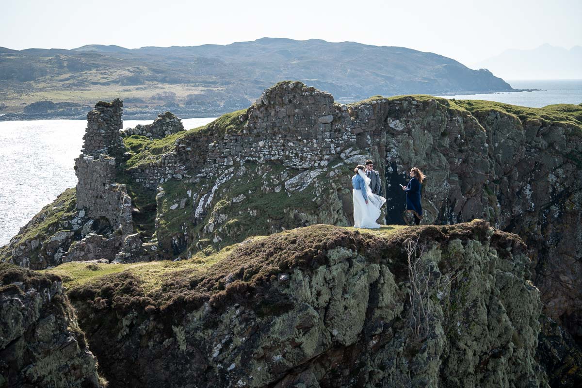 Adventurous couple eloping in a remote Skye landscape with dramatic light and wild scenery.