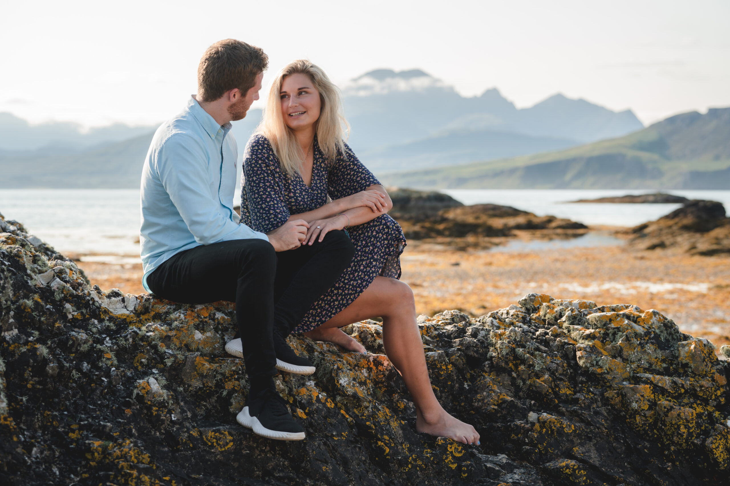What to wear for a family photoshoot on the Isle of Skye couple sitting together by the sea on the Isle of Skye