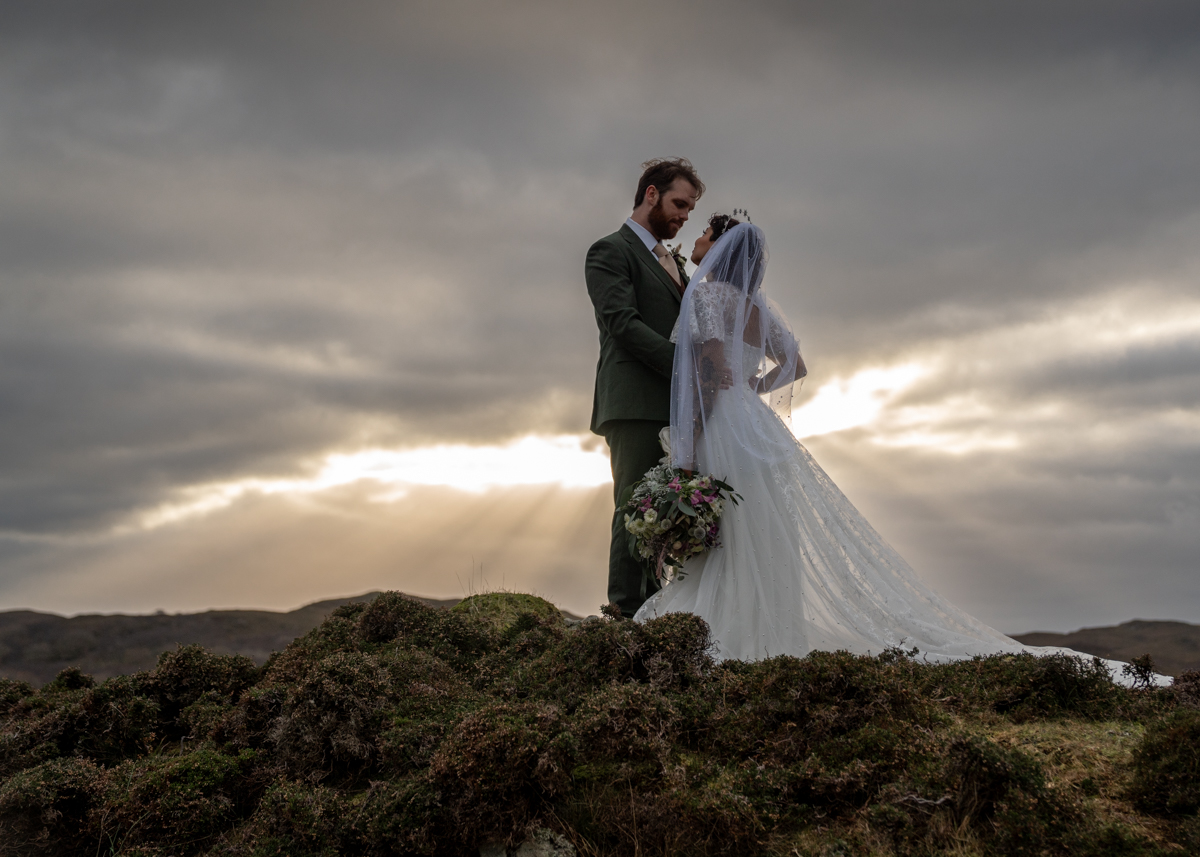 A couple get married at sunset on the Isle of Skye in the winter glow