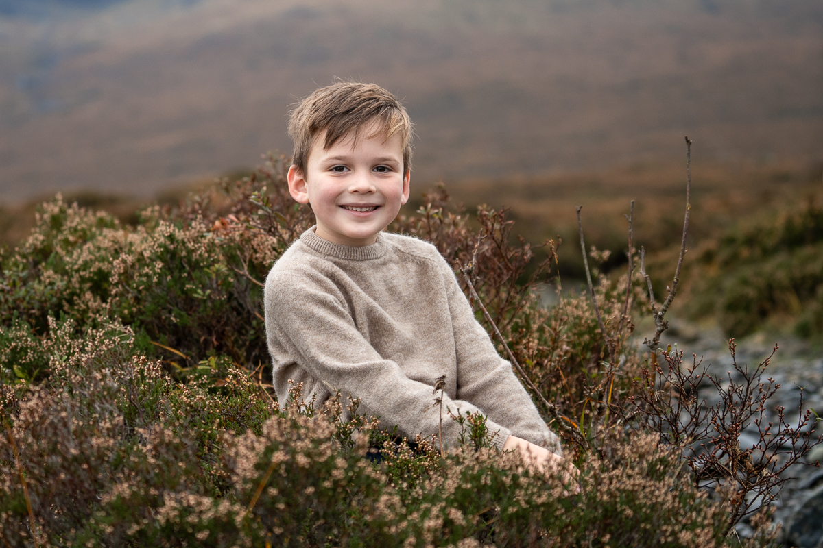 Young boy in a warm sweater in the gorse and heather on the Isle of Skye in Winter