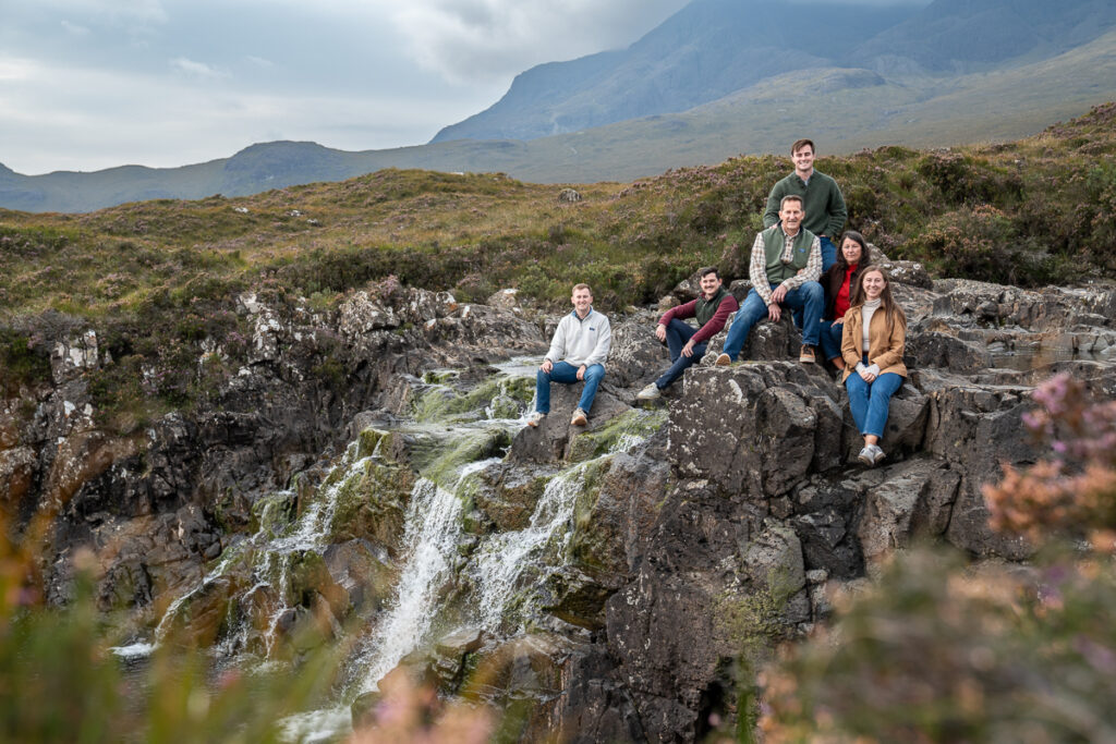 Natural family portrait with mountains in the background on Skye